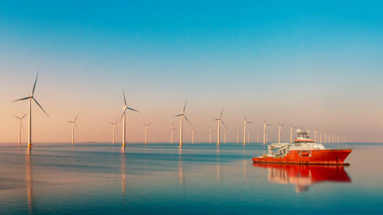 Windmill park with clouds and a blue sky, windmill park in the ocean aerial view with wind turbine Flevoland Netherlands Ijsselmeer. Green Energy production in the Netherlands on a sunny day