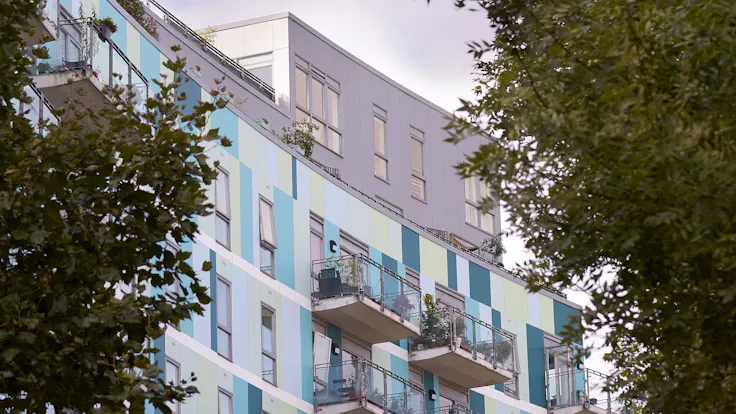 Eyot House (Multi Family House) in Bermondsey, London, United Kingdom cladded with A2 (FS-Xtra) in seven RAL colours plus Metallics Graphite Grey and Woods Cherry facade cladding.