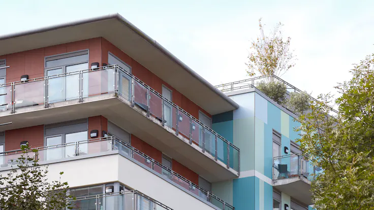 Eyot House (Multi Family House) in Bermondsey, London, United Kingdom cladded with A2 (FS-Xtra) in seven RAL colours plus Metallics Graphite Grey and Woods Cherry facade cladding.