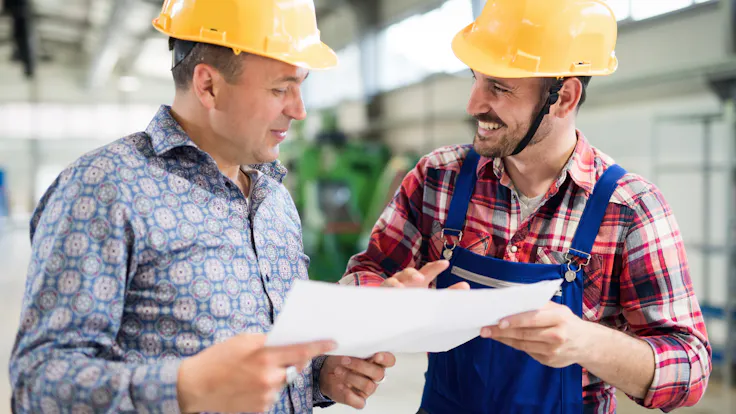Illustrative image, industry, worker, engineer, construction, building site, hard hat, blueprint, plan, document, collaboration